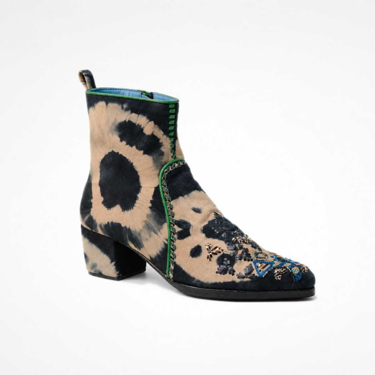 Angled view of the black-and-beige tie-dye suede MANI Point Heeled Boot with green piping and hand embroidery