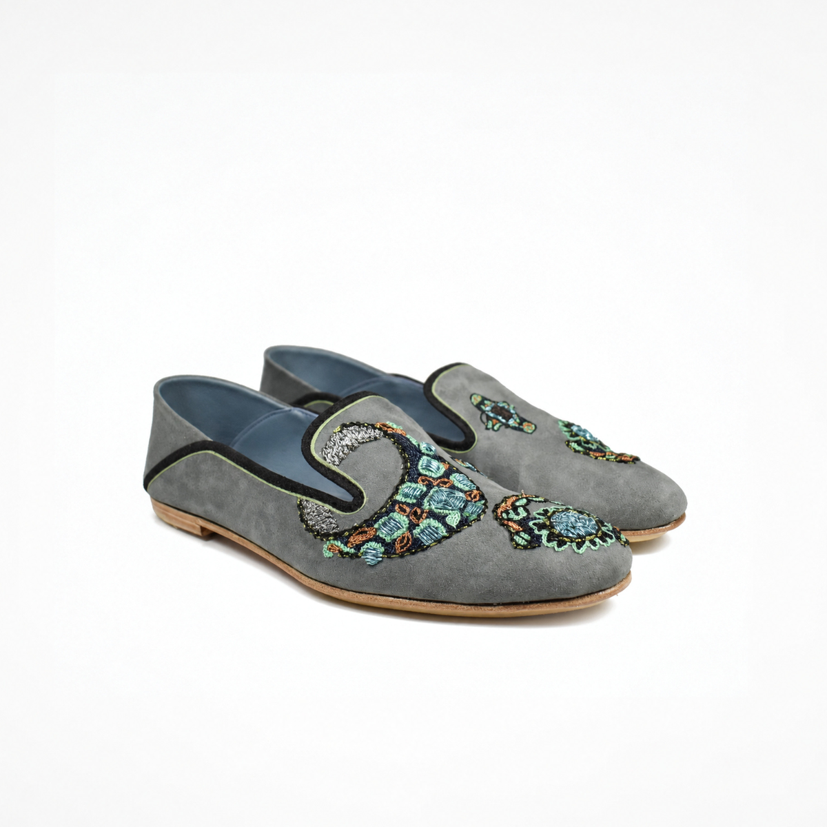 Angled view of a pair of grey suede VITI Loafers with hand-embroidered jewelled ring motifs
