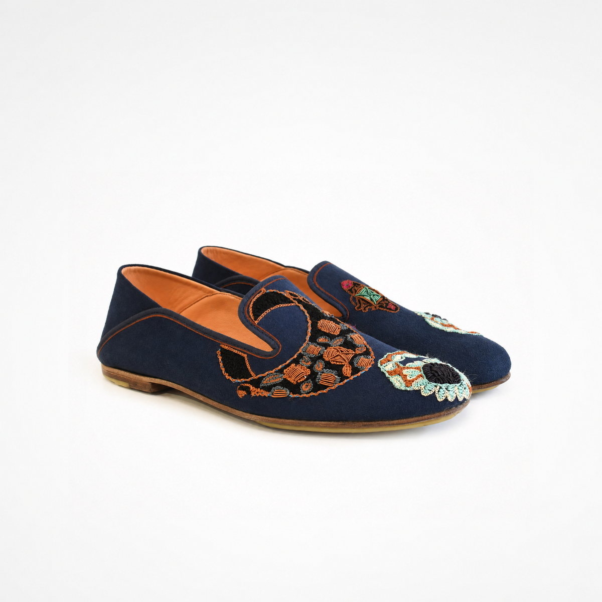 Angled view of a pair of navy suede VITI Loafers with jewelled ring embroidery