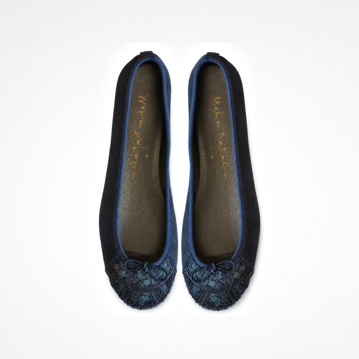 Pair of Bizi Ballet Classic flats in shiny black leather showing dark embroidered toe panels and bows