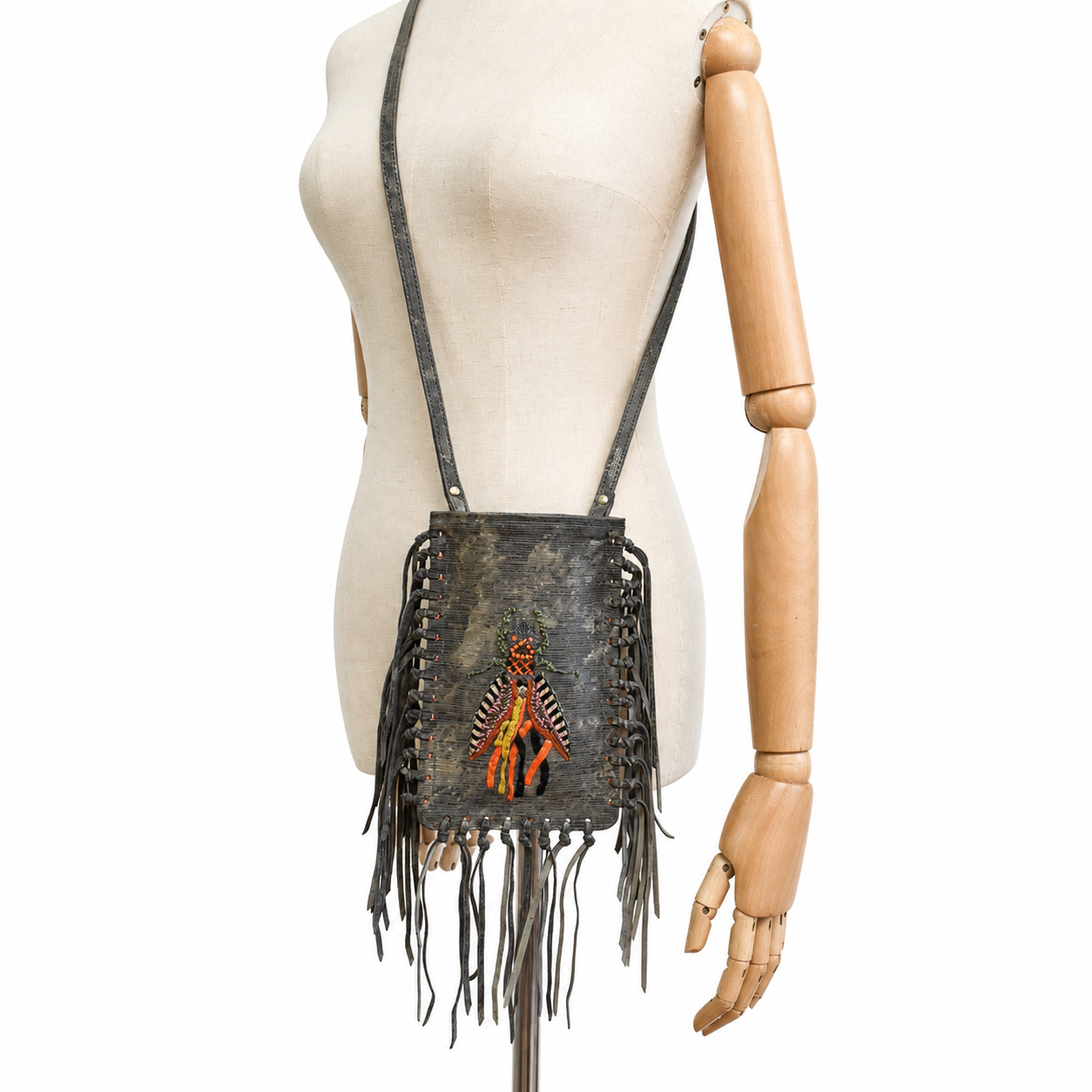 Mannequin wearing the brown leather FRINGE Phone Bag crossbody with embroidered insect motif and leather fringe