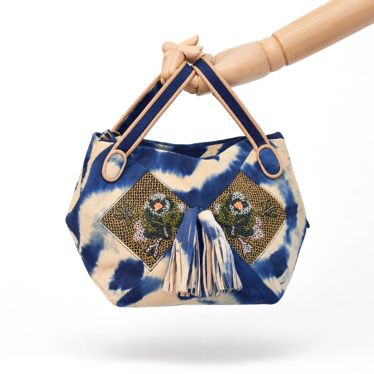 Blue and beige tie-dye suede NORA BUNNY BAG held by its leather handles