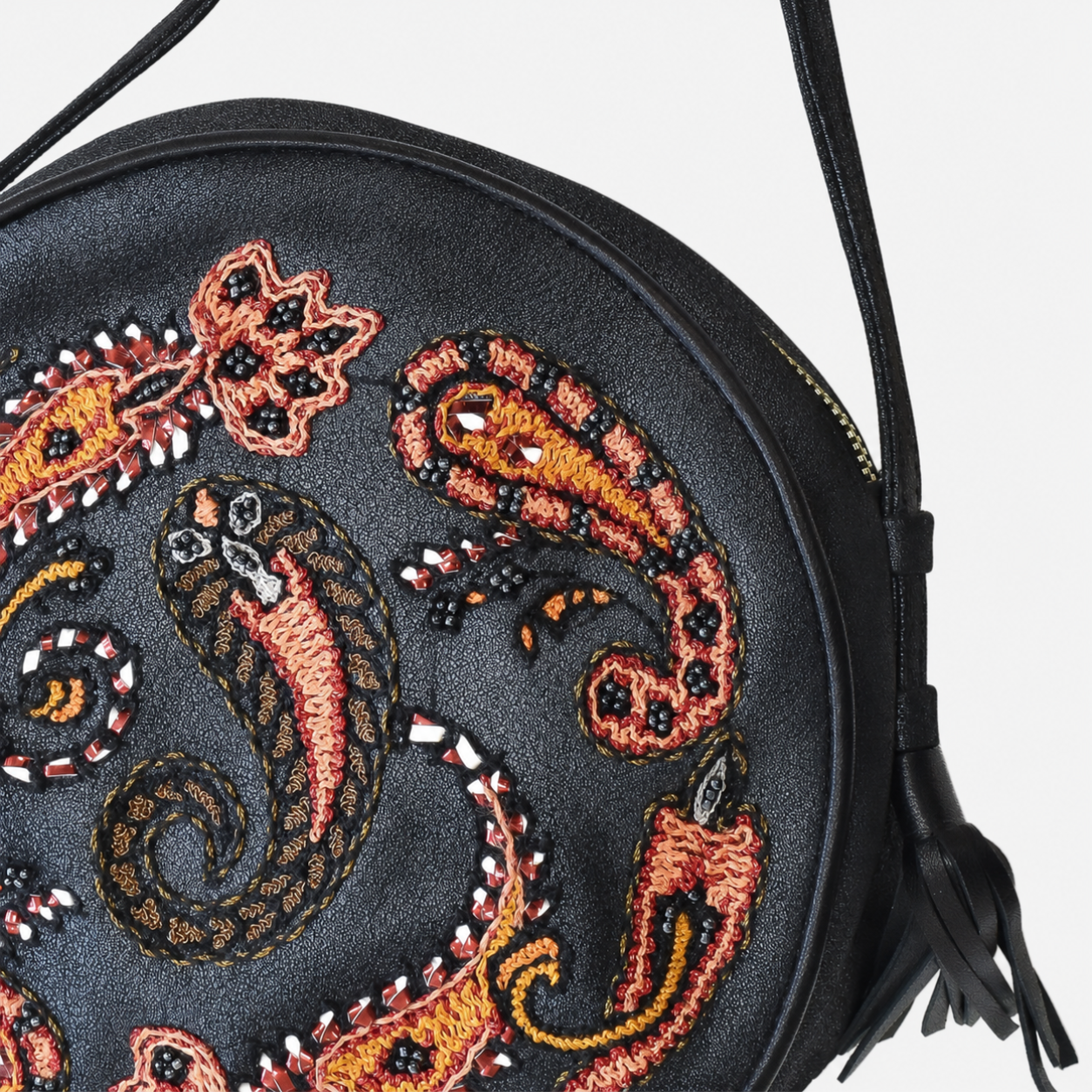 Close-up of Phyllis Round Bag in shiny black leather showing paisley embroidery, beadwork and reflective embellishments