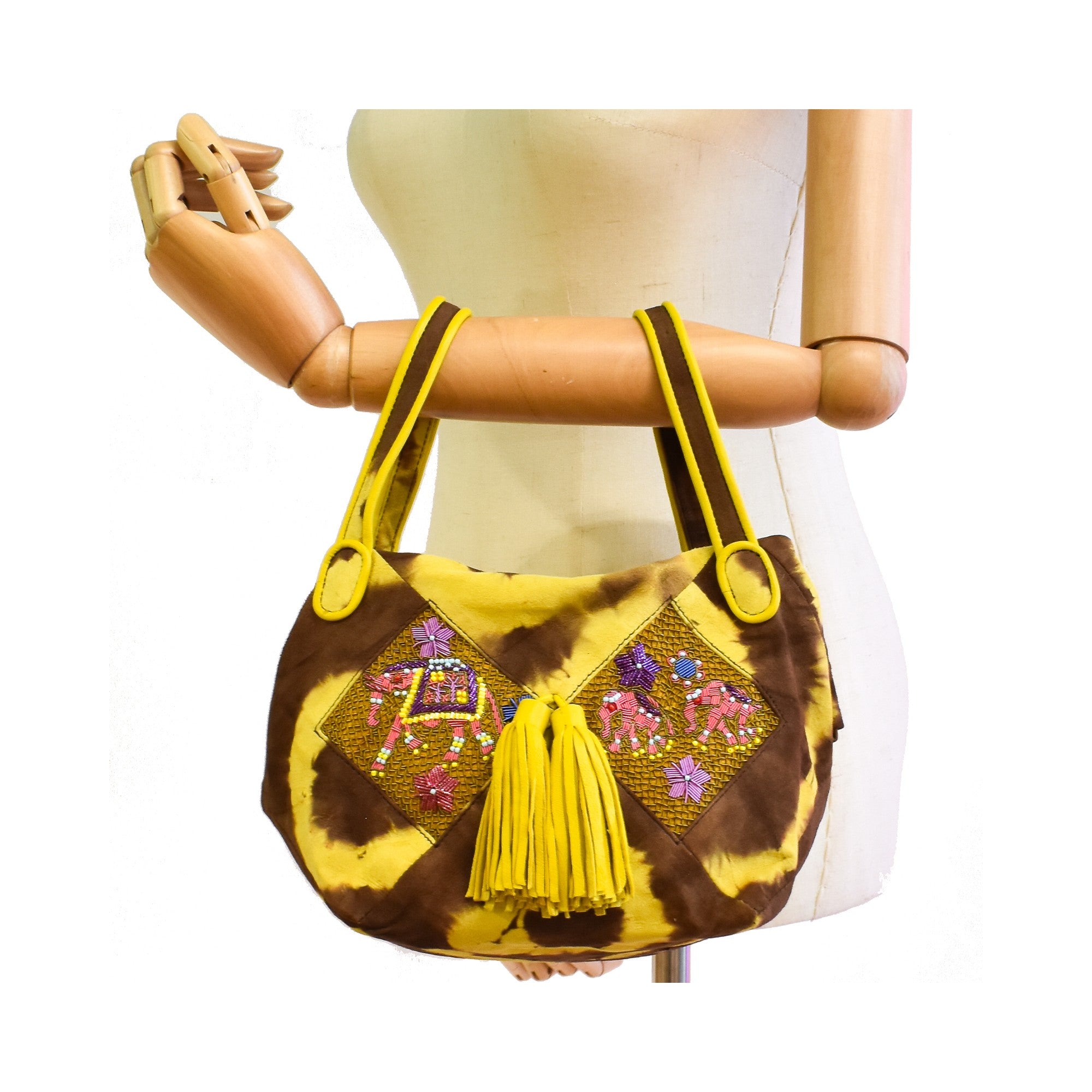 Brown and yellow artisan handbag with leather tassels and coil embroidery