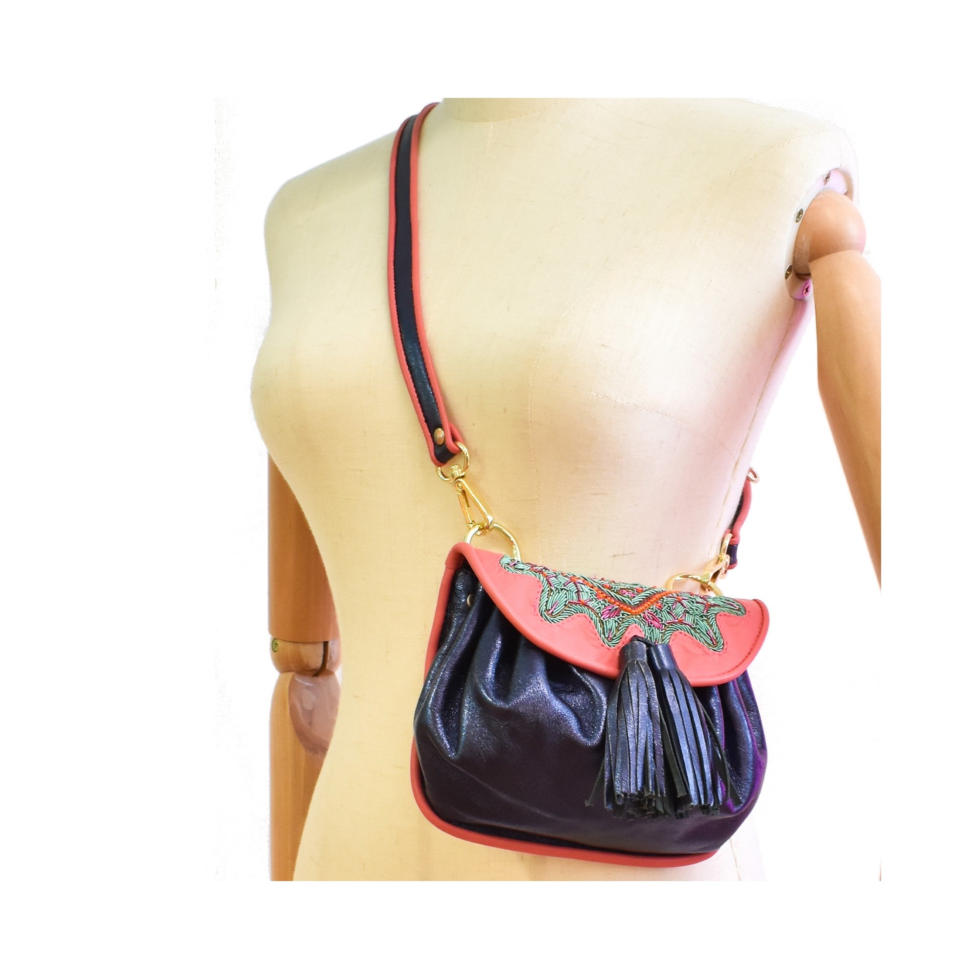 Sonic sapphire leather crossbody bag with lady pink flap and artisan embroidery.