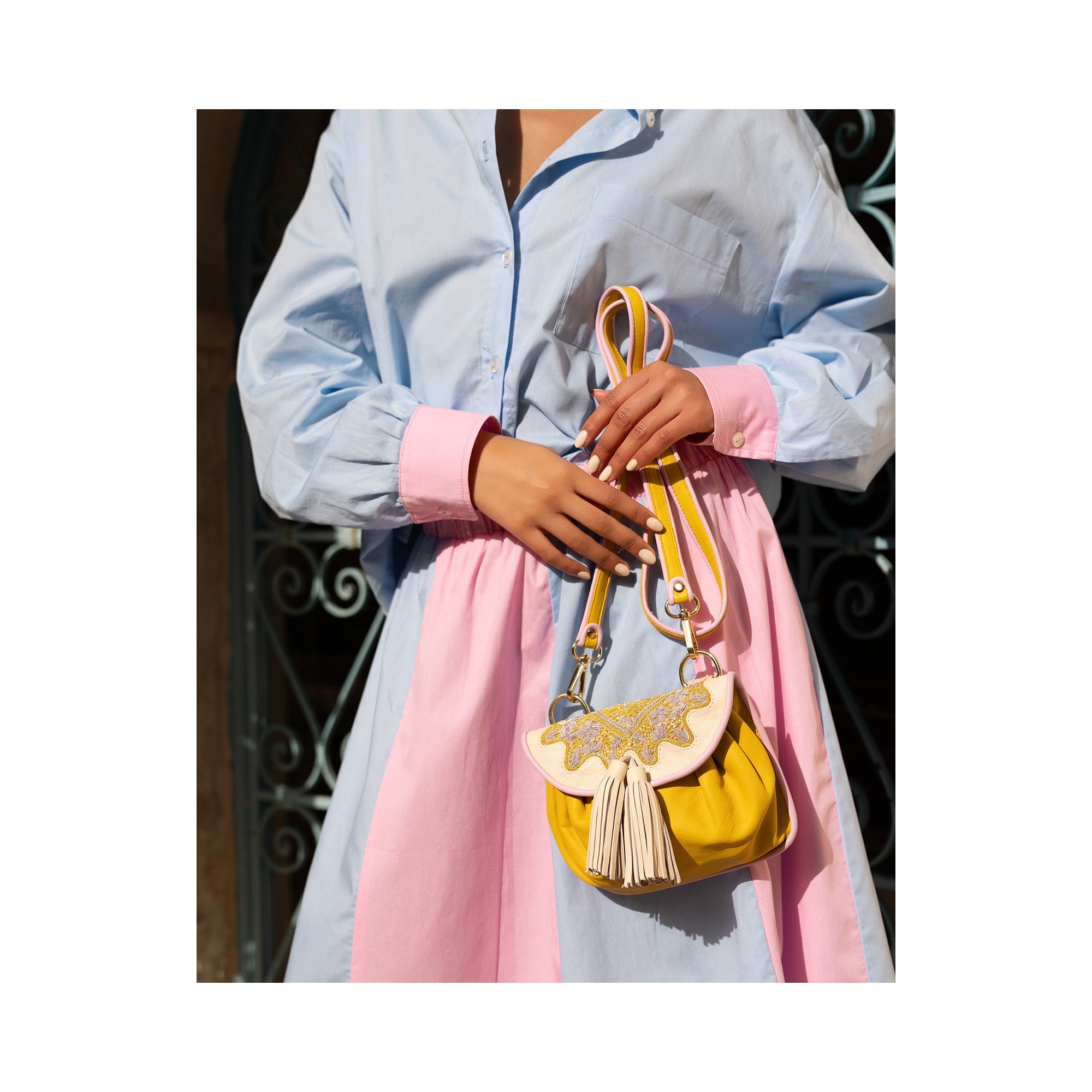 Women’s leather waist bag in bright yellow with artisan hand embroidery.