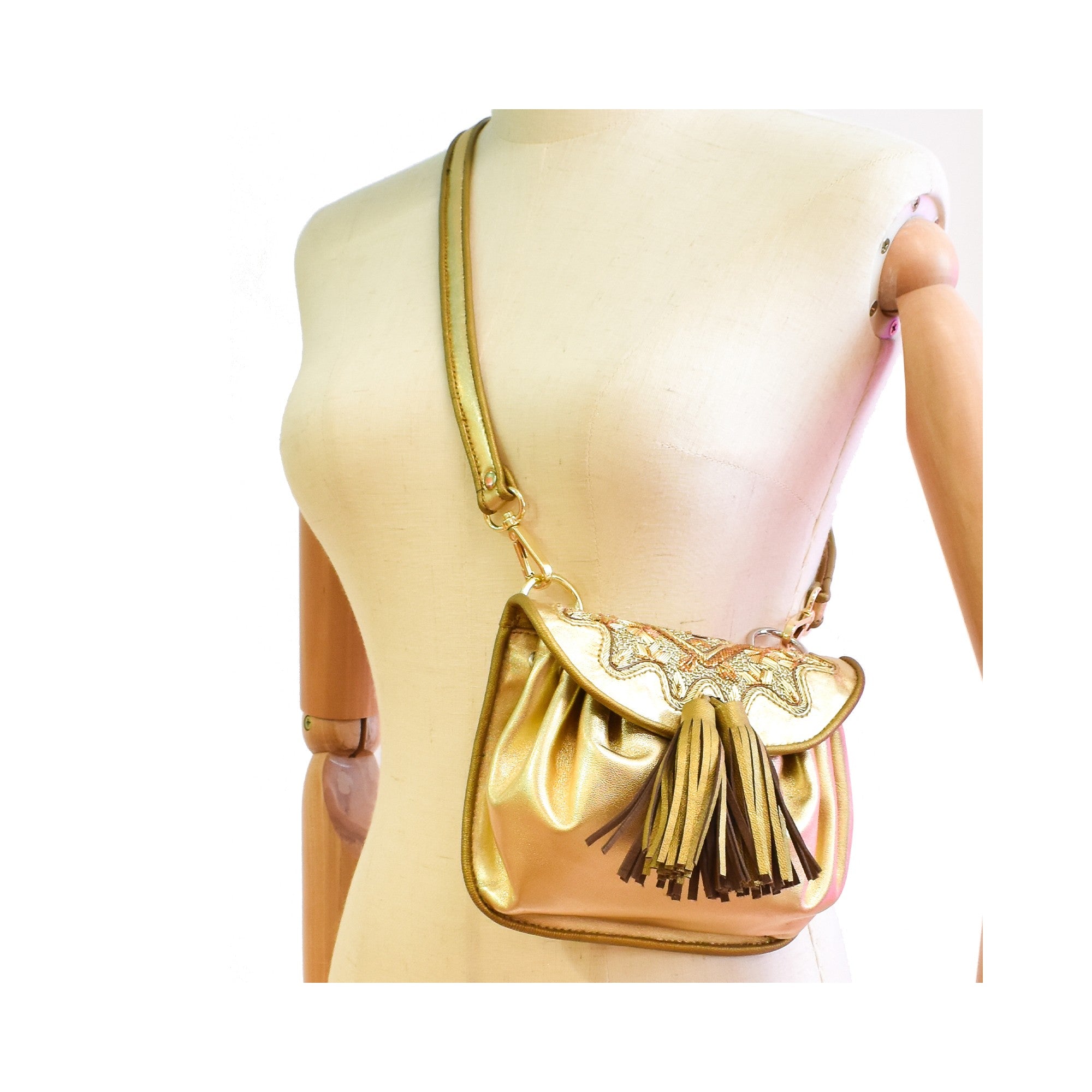 Sonic gold leather crossbody bag with tonal hand embroidery.
