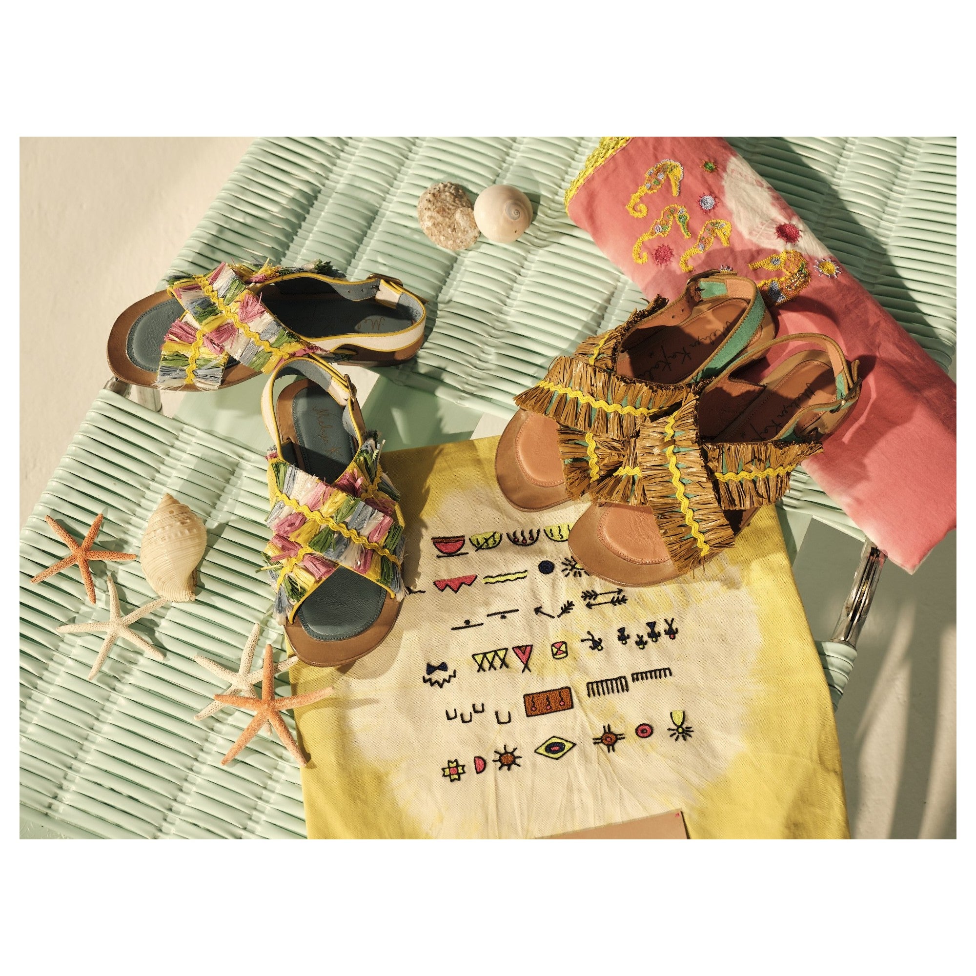 Group shot of colourful Meher Kakalia sandals styled with embroidered accessories and shell decor, celebrating artisan fashion.