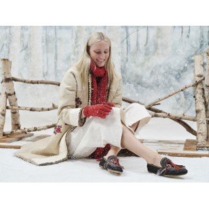 Woman wearing luxurious OUD moccasins outdoors with long coat and tights