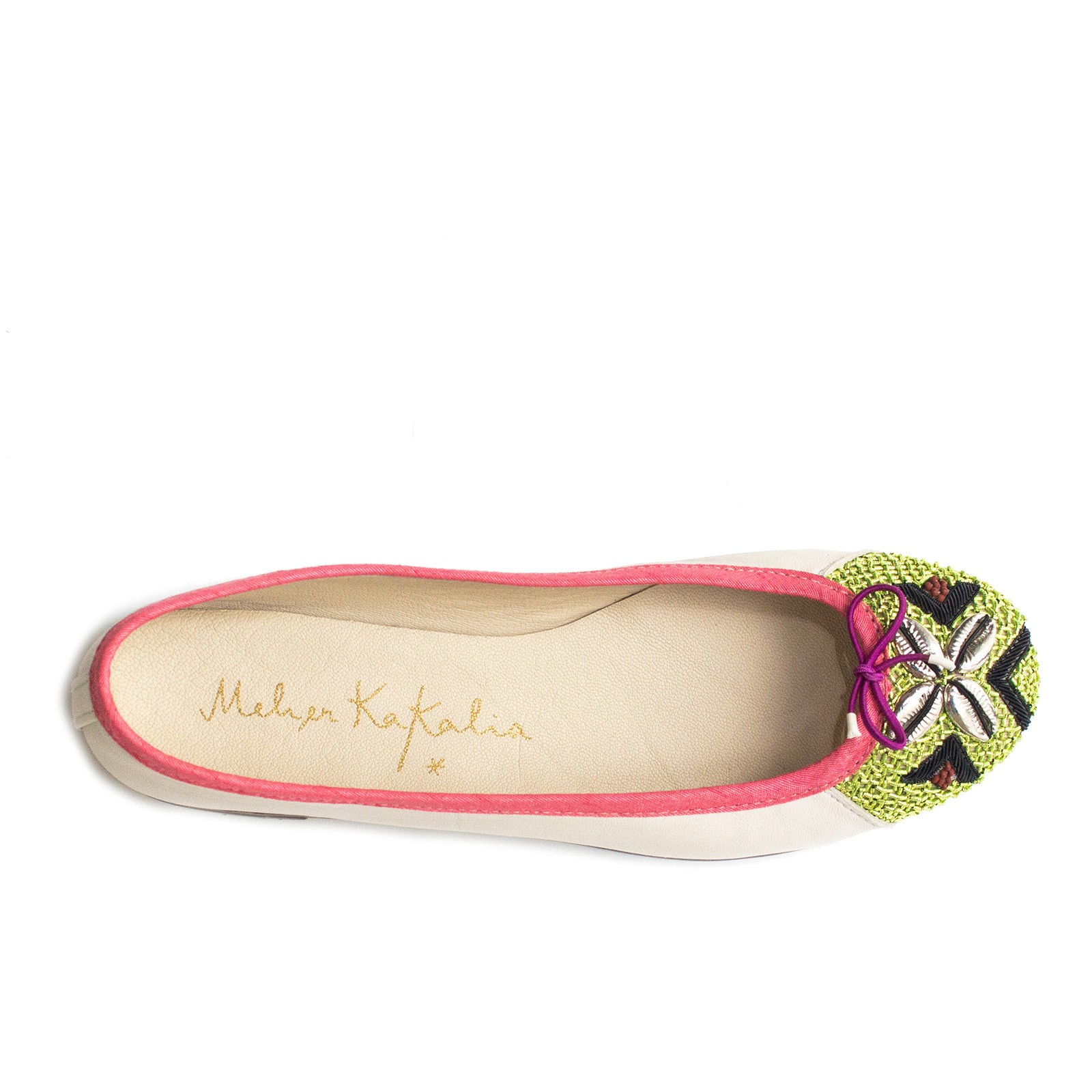 White leather ballerina with green and black embroidered toe and cowrie shells, top view.