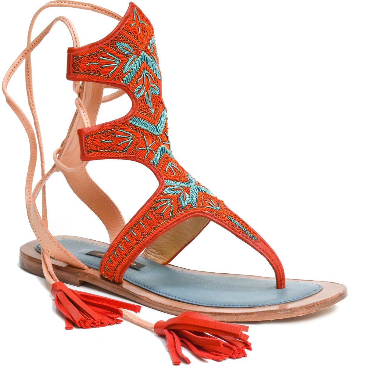 Side view of Clio Sandal in orange, a toe gladiator sandal with coil embroidery and wraparound leather ties for a secure fit.
