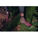 Meher KakaliaBurgundy embroidered suede ankle boots with tribal motifs worn outdoors