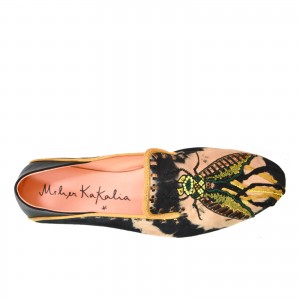 Elegant suede moccasins with black and beige tie-dye effect and metallic thread embroidery, shown from top angle.