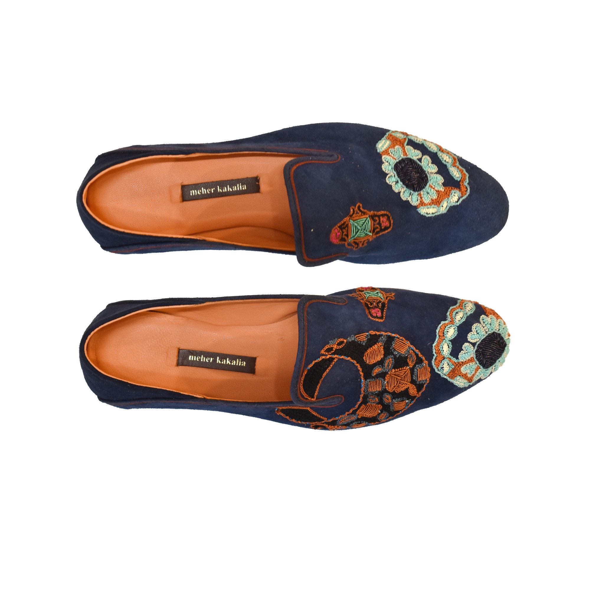 Meher Kakalia Top view of Meher Kakalia Viti Moccasin in navy suede with ring-shaped embroidery.