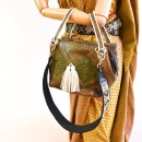 Meher KakaliaMeher Kakalia Bunny Bag worn on the shoulder, showcasing croc-embossed army leather and hand-embroidered green panels.