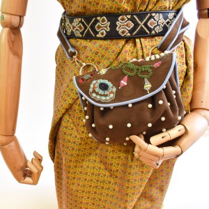 Jewel Accordion Bag in suede toffee worn on a mannequin as a belt bag with adjustable strap.