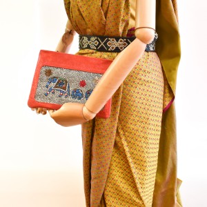 Coral elephant-embroidery pochette made from small leather stock, styled with a beige dress