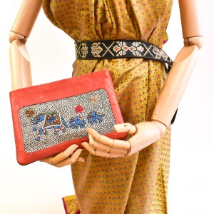 Mannequin holding the limited-edition coral elephant-embroidered pochette