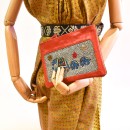 Meher KakaliaSide view of the coral leather limited-edition pochette with traditional elephant embroidery