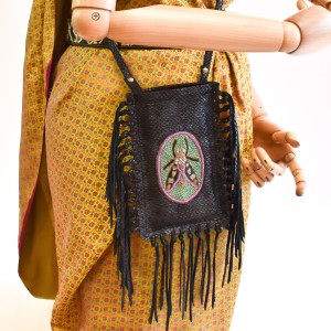 Side view of the limited-edition magma black fringe phone bag with long fringes