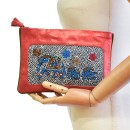Meher KakaliaMannequin holding the limited-edition coral elephant-embroidered pochette