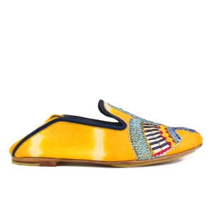 Side view of ANZU Moccasin TD saffron in yellow tie-dye suede leather with navy trim and embroidered vamp motif