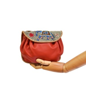 Women’s red leather shoulder bag with handcrafted embroidered flap and gold hardware.