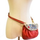 Meher KakaliaRed leather accordion bag with traditional coil embroidery and elephant motif.