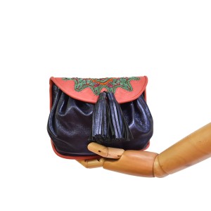 Women’s leather waist bag with hand embroidery and gold hardware.