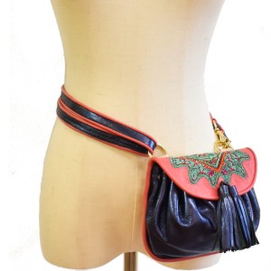 Mini leather belt bag in deep blue with pink embroidered flap and tassels.