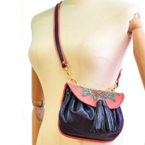 Sonic sapphire leather crossbody bag with lady pink flap and artisan embroidery.