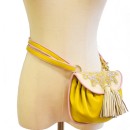 Meher KakaliaYellow leather mini belt bag with white embroidered flap and tassels.