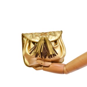 Women’s metallic leather waist bag in gold with adjustable strap.