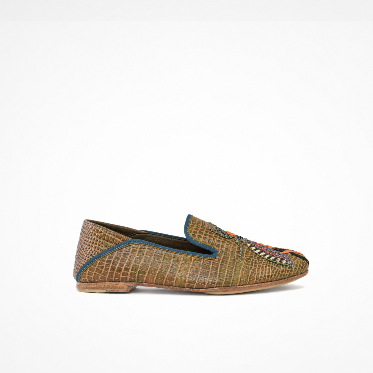 Side view of an olive-brown croc-effect leather Luna Loafer with blue piping and multicolour embroidered insect motif