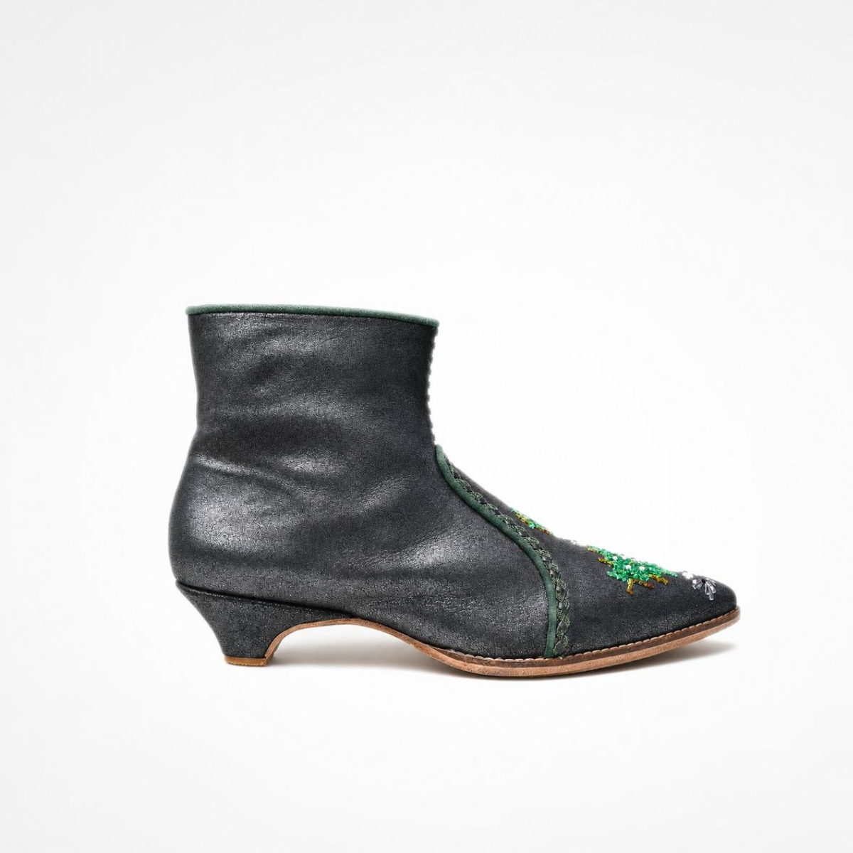 Shiny black leather NANA heeled ankle boot with green embroidered motifs, side view