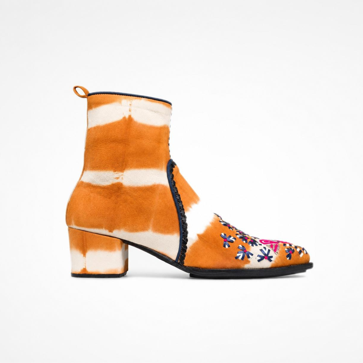 Side view of the orange-and-cream tie-dye suede MANI Point Heeled Boot with hand embroidery and block heel