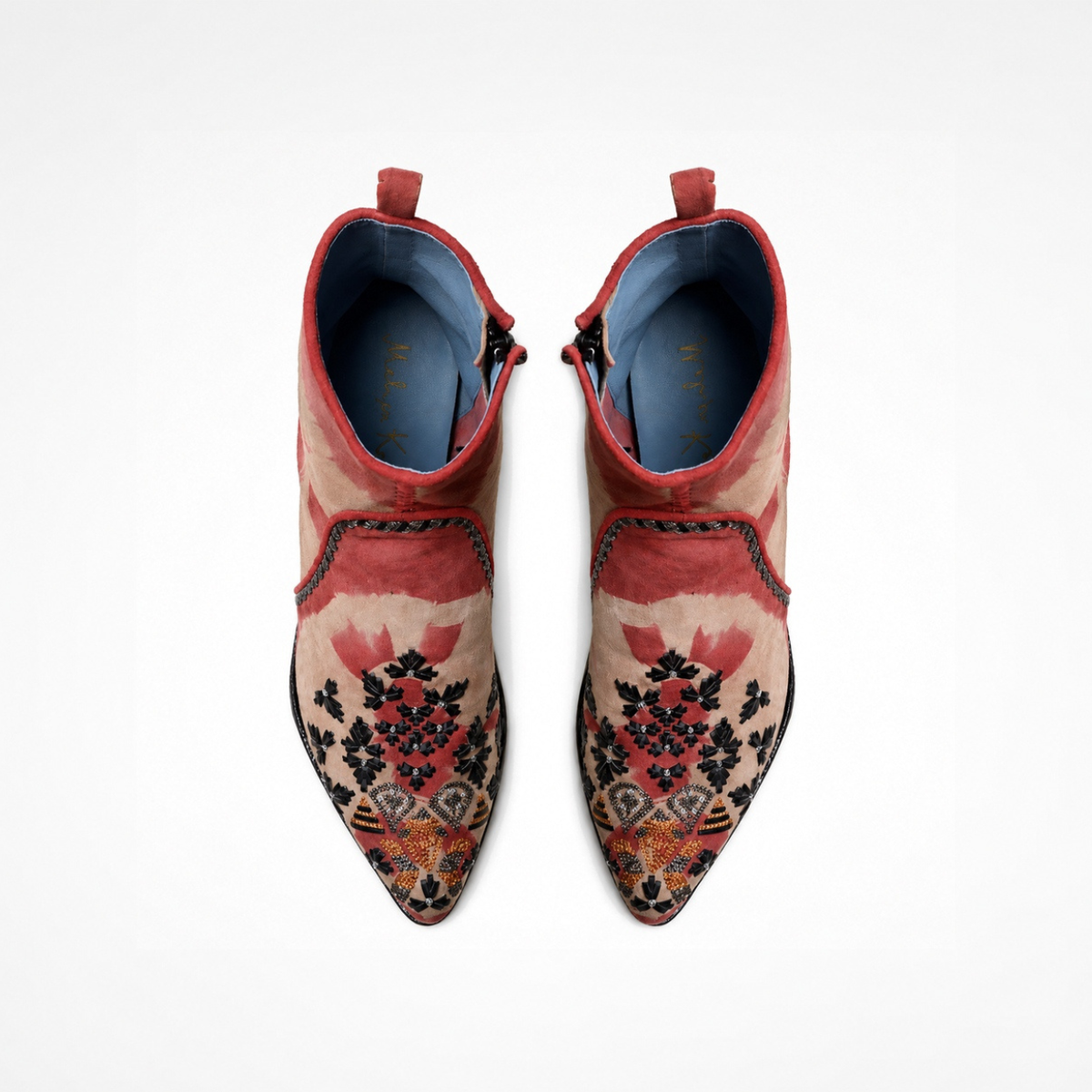Top view of a pair of red-and-beige tie-dye suede MANI Point Heeled Boots with embroidered pointed toes