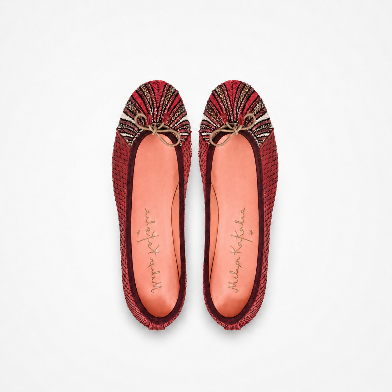 Pair of cranberry-red Miami ballet flats with radiating red, cream and bronze embroidery and bow details