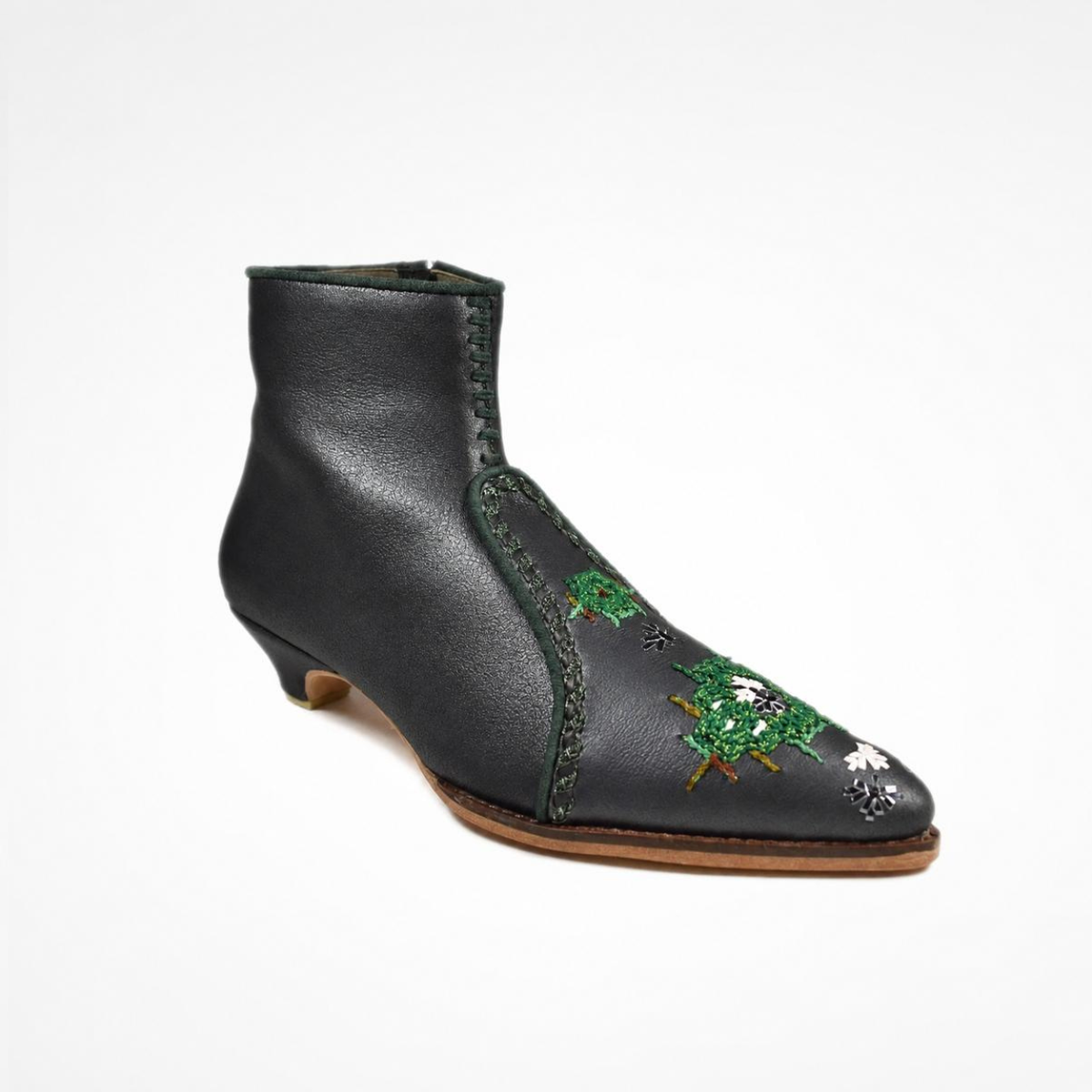 Shiny black leather NANA heeled ankle boot with pointed toe and green embroidery, three-quarter view