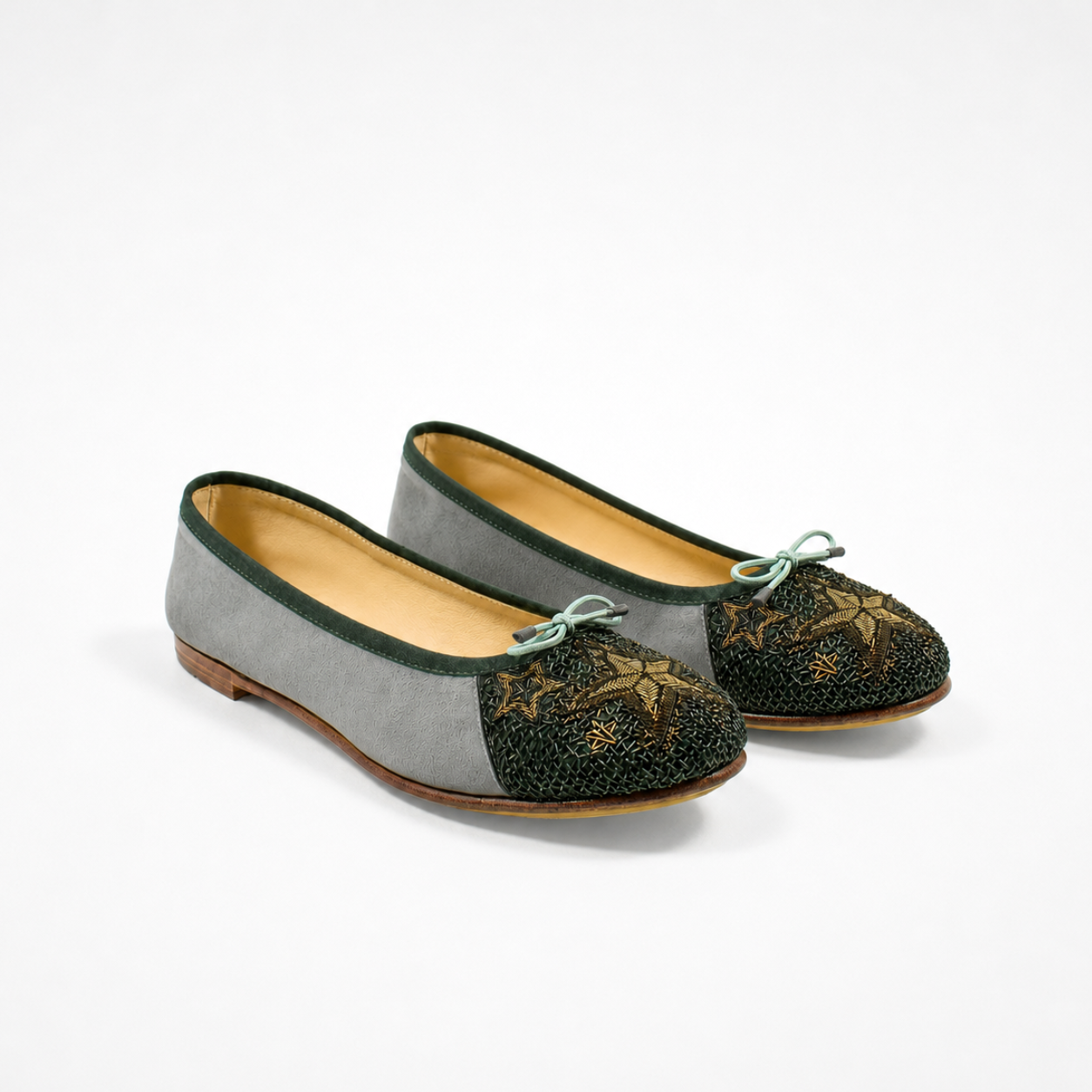 Pair of grey suede Starry Night ballet flats with dark embroidered toes and metallic celestial motifs