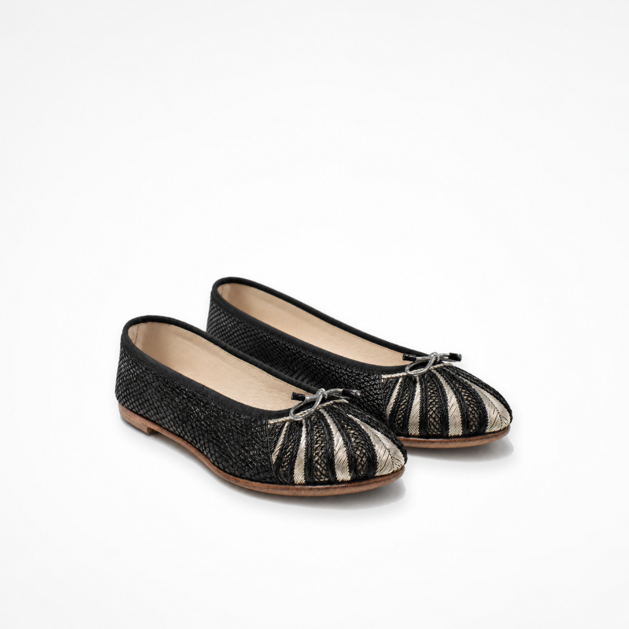 Pair of black textured leather Miami ballet flats with embroidered rounded toes and metallic bow details