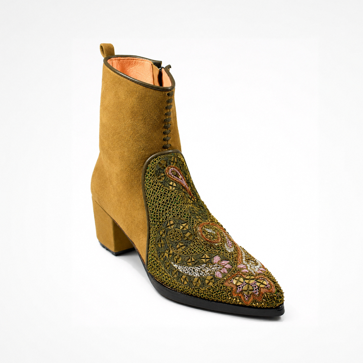 Angled view of the ochre suede QUEEN PHYLLIS pointed heeled boot with an olive hand-embroidered paisley front panel

