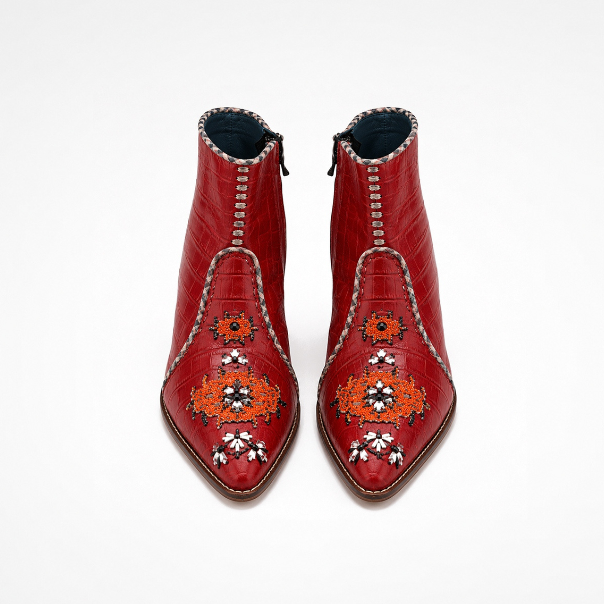 Pair of red croc-effect leather NANA heeled ankle boots with orange and silver embroidery, front view