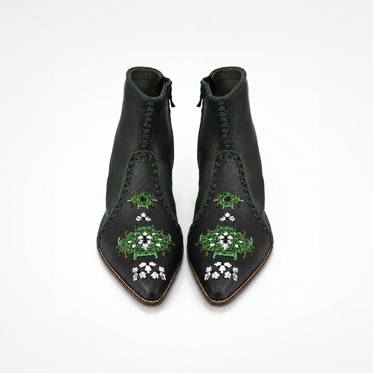 Pair of shiny black leather NANA heeled ankle boots with green and silver embroidery, front view