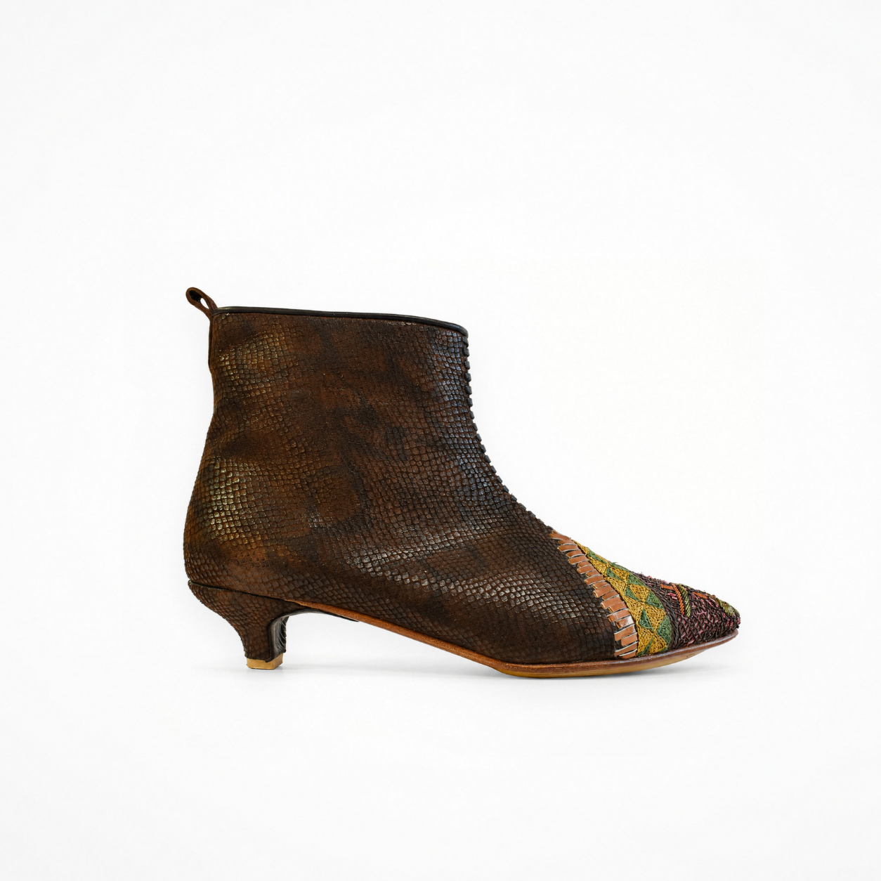 Side view of a brown textured leather Astrid heeled boot with pointed embroidered toe, fitted ankle shaft and low heel