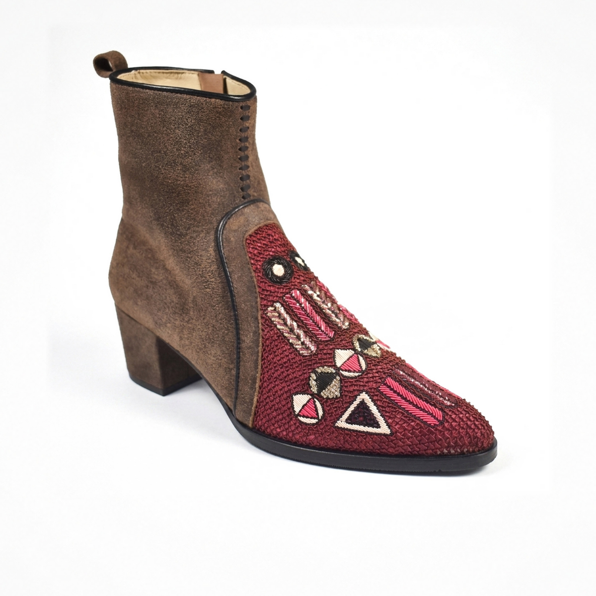 Angled view of the brown suede QUEEN BAUHAUS pointed heeled boot with a burgundy geometric hand-embroidered front panel