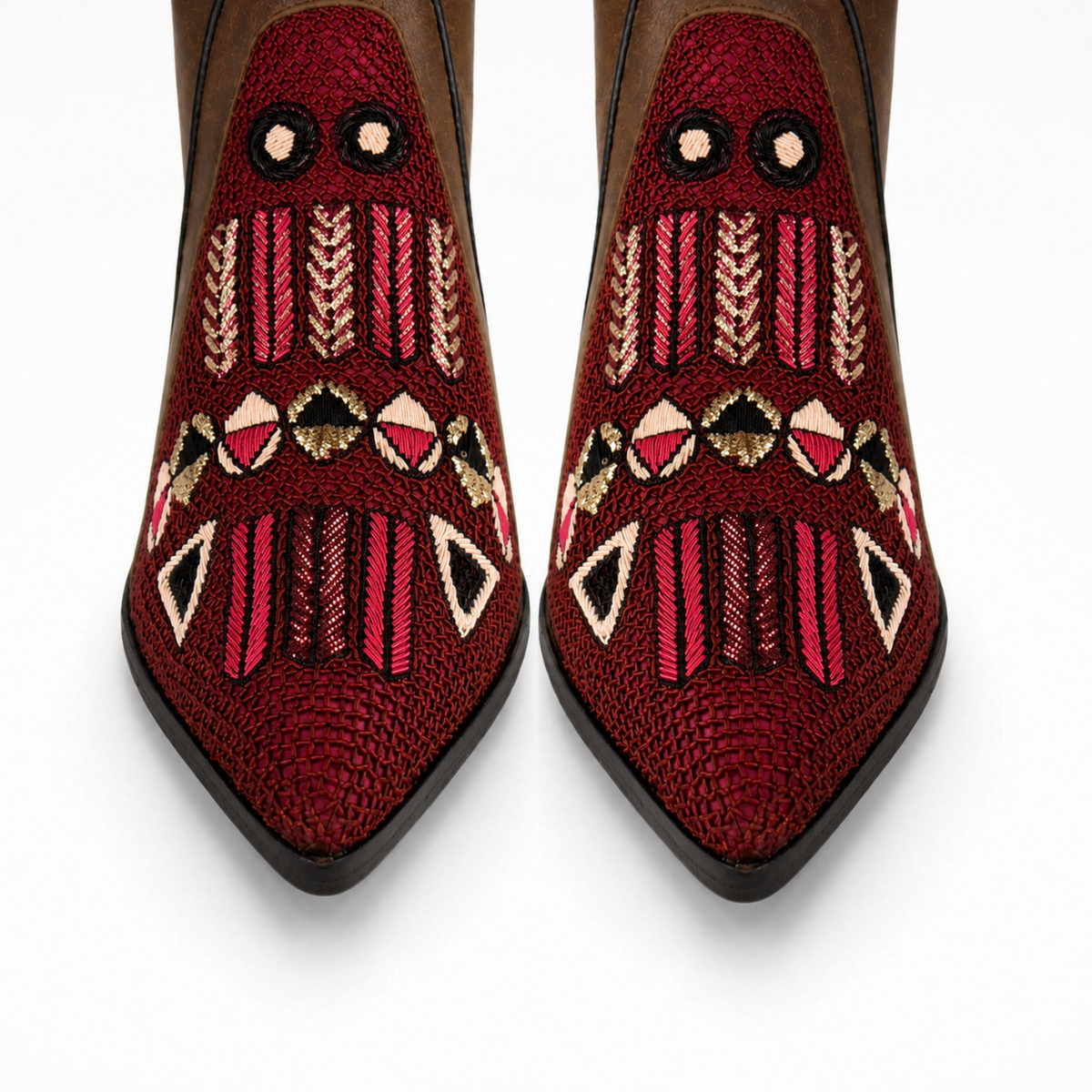 Front close-up of a pair of brown suede QUEEN BAUHAUS pointed heeled boots with burgundy geometric hand embroidery