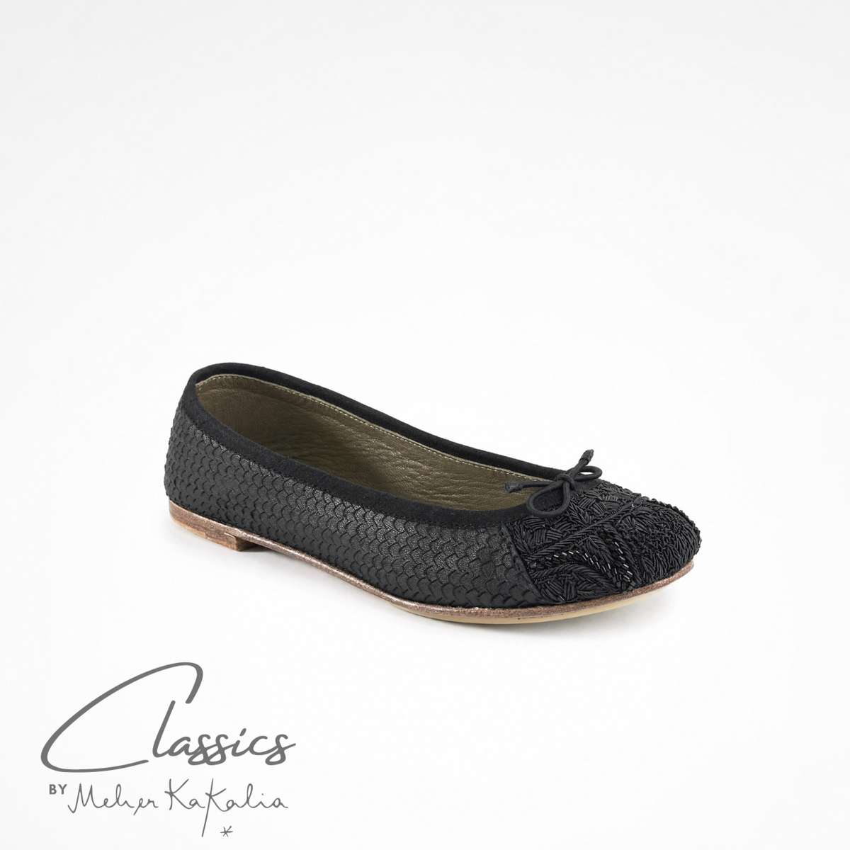 Black leather BIZI ballet flat with hand-embroidered toe cap, angled view