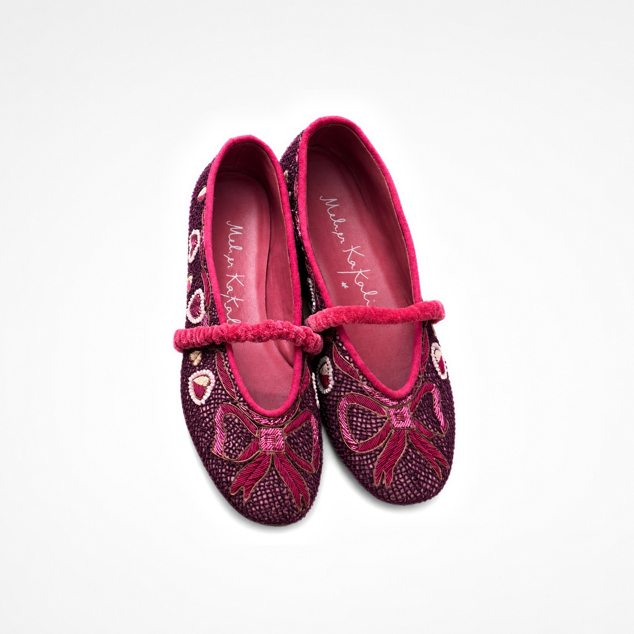 Pair of Darcey Ballet flats in burgundy showing bow embroidery, heart motifs and ruched straps