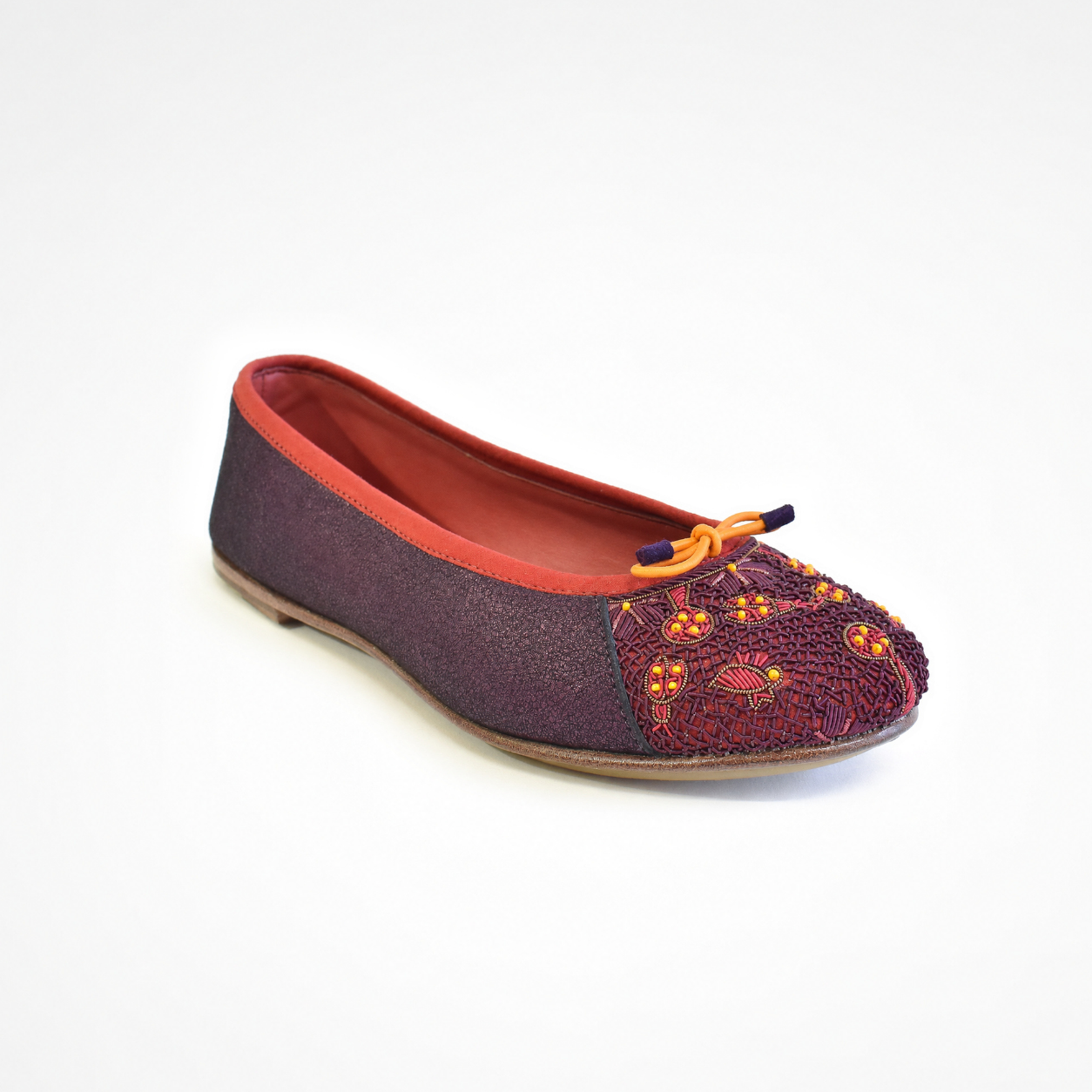 Eden Ballet flat in beige and black leather, angled view with embroidered toe and bow 